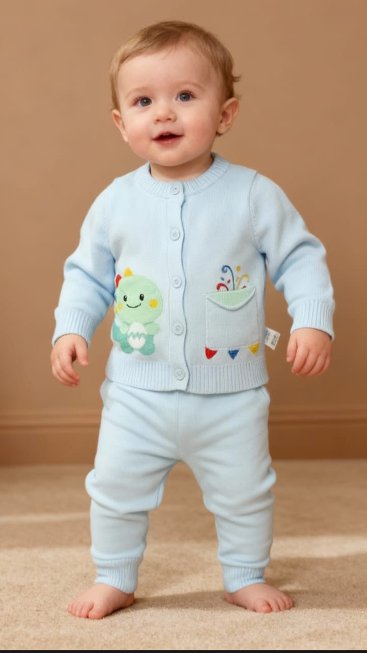 Baby wearing a light blue outfit with colorful designs on a beige background